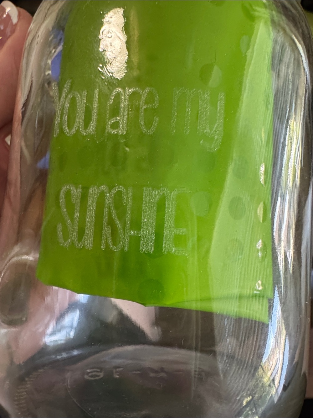 Clear Glass Mason Jar with Handle “You Are My Sunshine” is engraved on the front